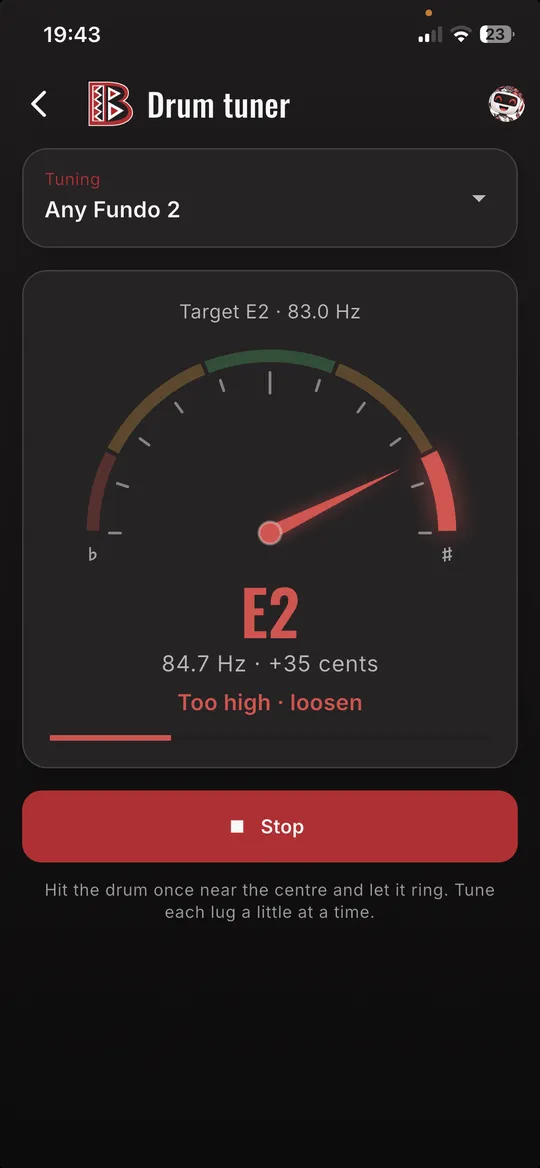 Batala drum tuner telling the player the drum is too high
